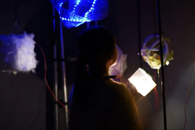 Visitor interacting with light installation