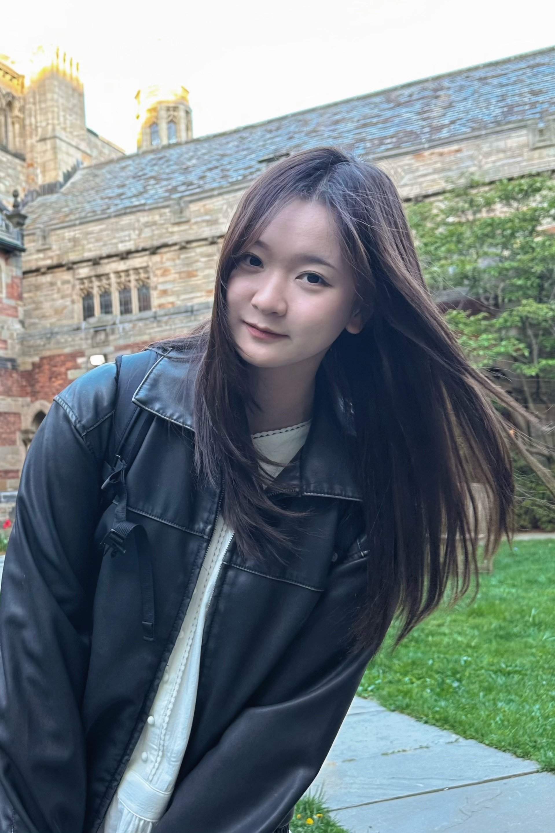 Jingchen Gao outdoors beside a historic stone building